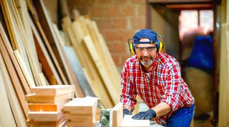 man using table saw needs a table saw cover to prevent rust and corrosoin