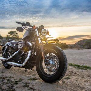 Black cruiser motorcycle parked on desert road prevent motorcycle rust