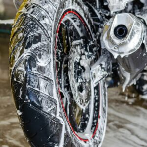 sport bike covered in soap suds while being cleaned