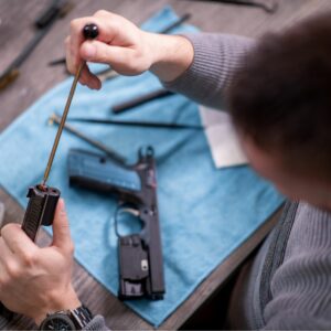 man cleaning gun using Zerust gun oil to prevent rust