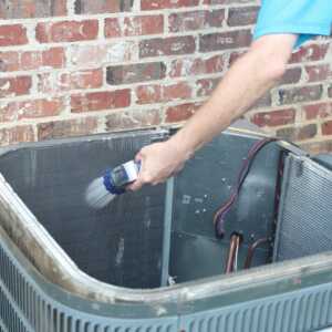ac unit cleaning coils with a hose