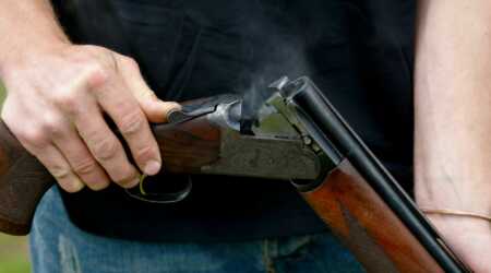 man loading shotgun shells
