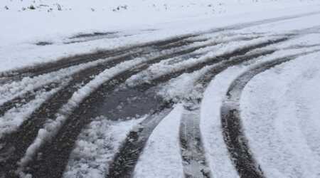road with applied salt covered in snow and slush