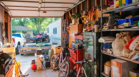Messy garage with tools, bicycles, and general storage