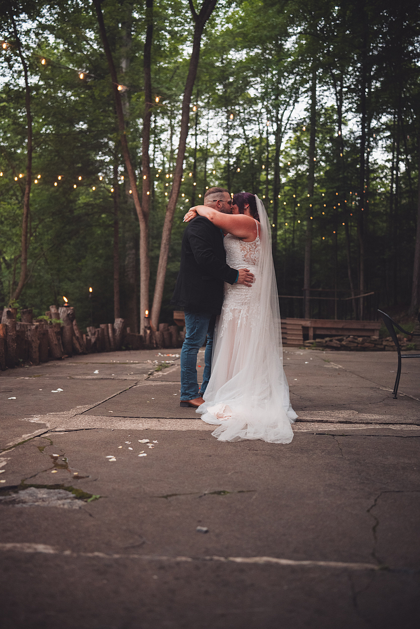 Couple beneath string lights at The Lodge at Water's Edge
