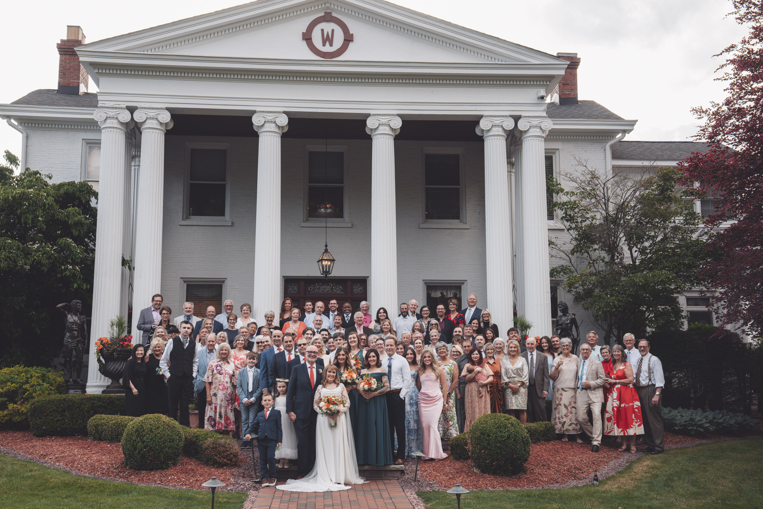 Tara A Country Inn full mansion facade, white pillars, and wedding guests