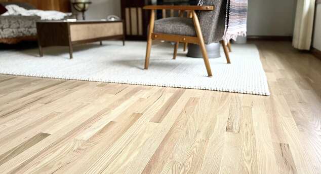Light Red Oak Floor. Area carpet and furniture.