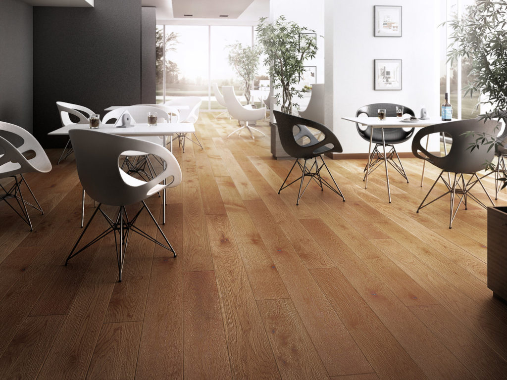 honey wood floor with modern white chairs