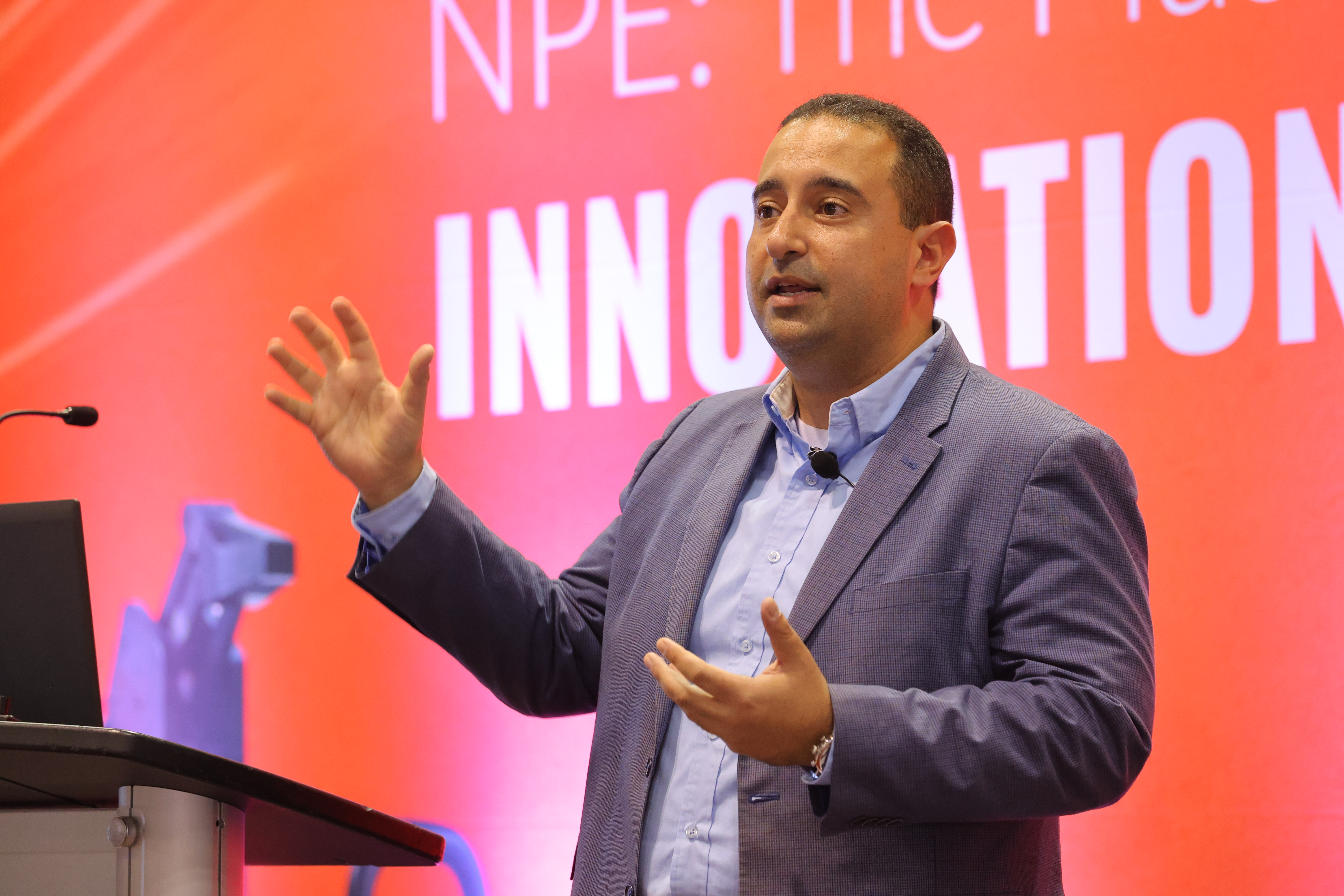 Speaker presenting on an NPE show floor stage