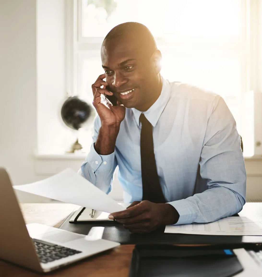 man-on-phone-and-with-laptop