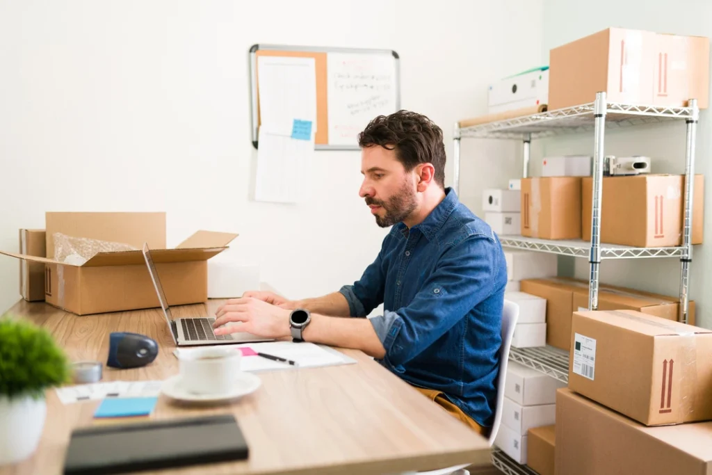 Desk with laptop and boxes, representing inventory setup for rentals
