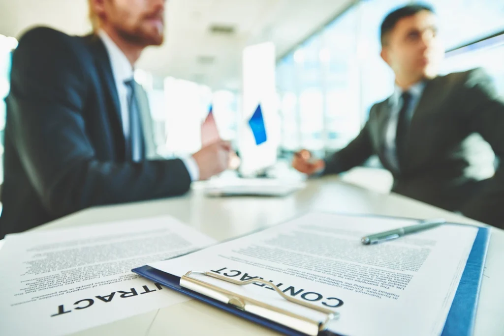 Two professionals signing a business contract for registration in 2025