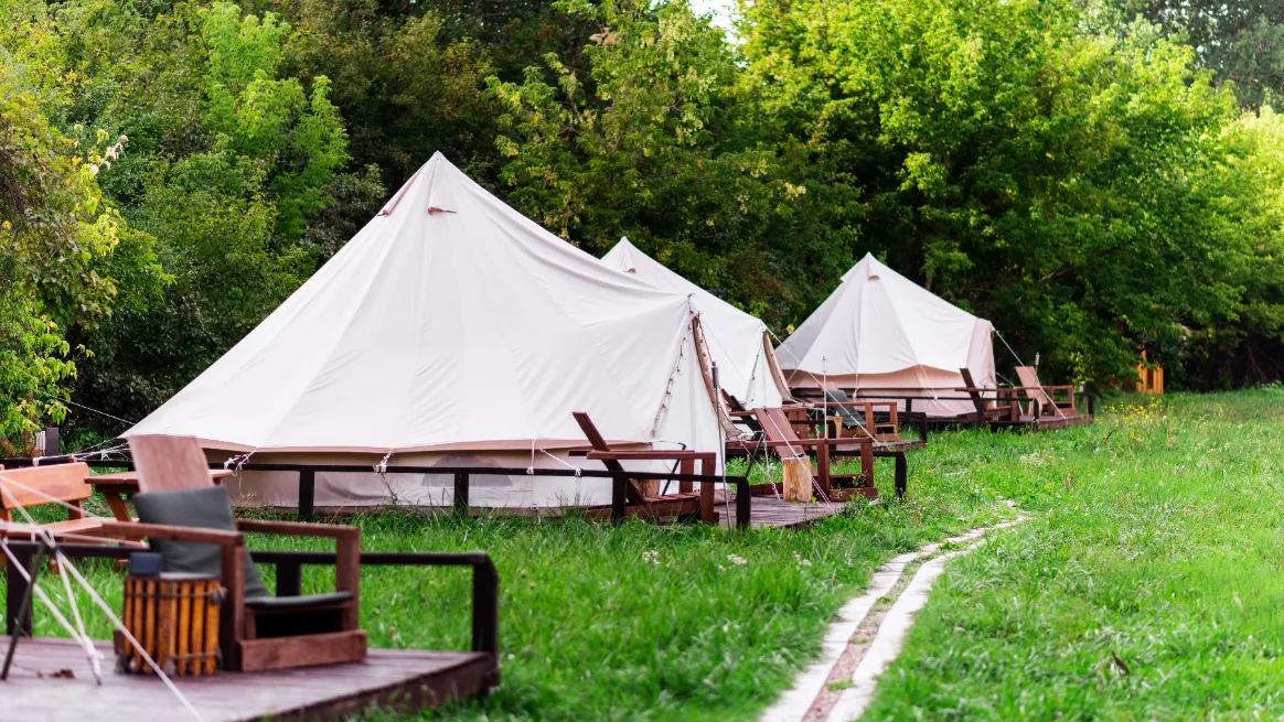 Canvas tents displayed in a rental showroom with various sizes and styles