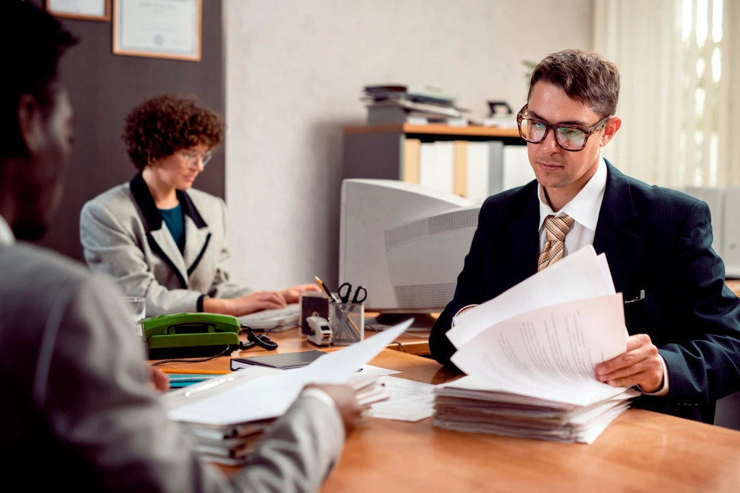 Professionals reviewing legal documents for van rental business setup.