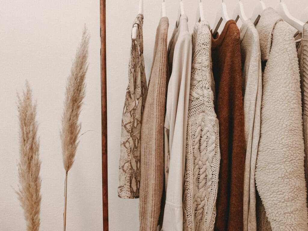A woman browsing through clothing rentals in a boutique