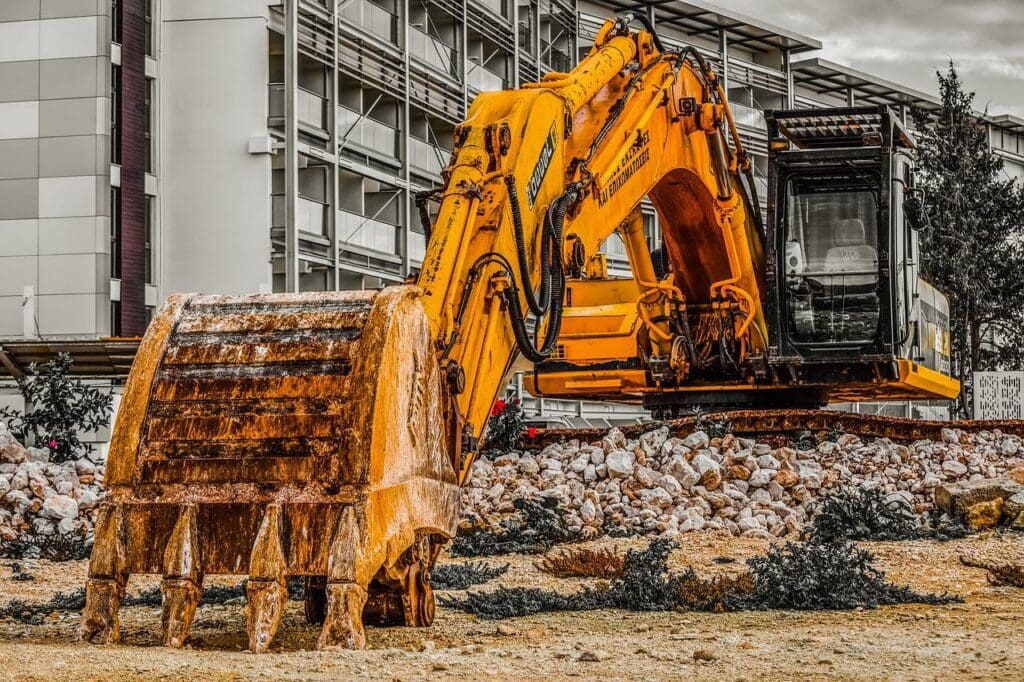 Heavy equipment like cranes and transit mixers on a construction site