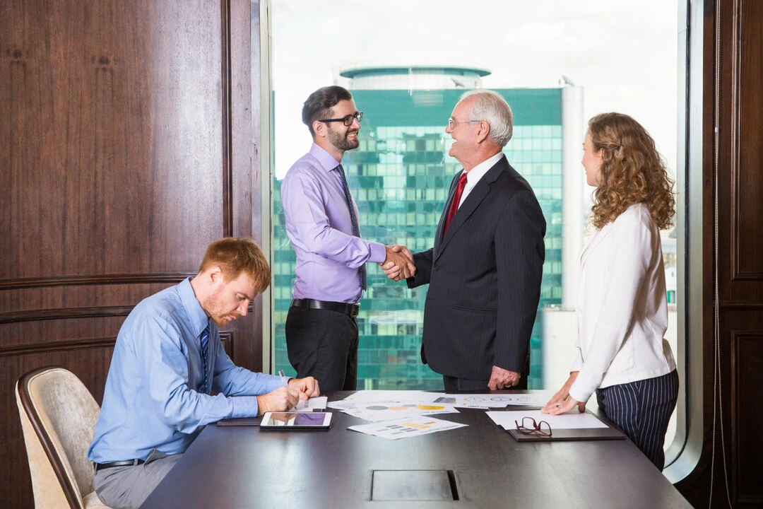 Business partnership handshake meeting to expand rental reach