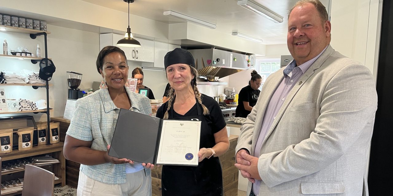 Minister presents certificate at Chute-à-Blondeau café