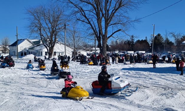 Vintage snowmobiles and sunny skies