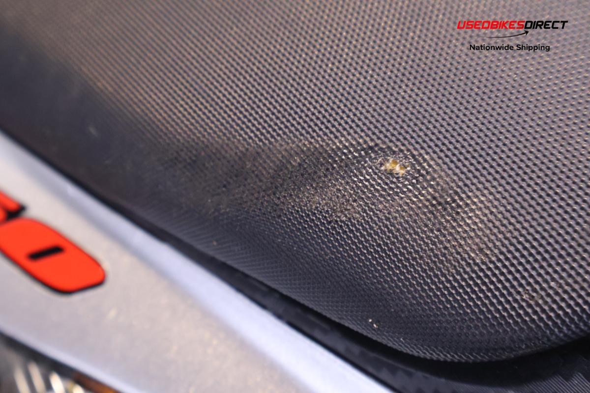 rear seat wear, road rash on side faring and cover, scratches on front wheel faring