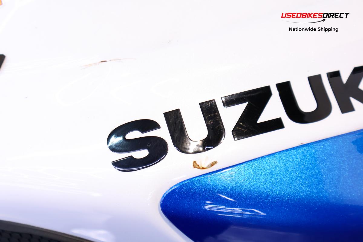 rust and dent on tank, cracks and paint chips on faring pieces, road rash on rear peg and gap on faring piece near tank.