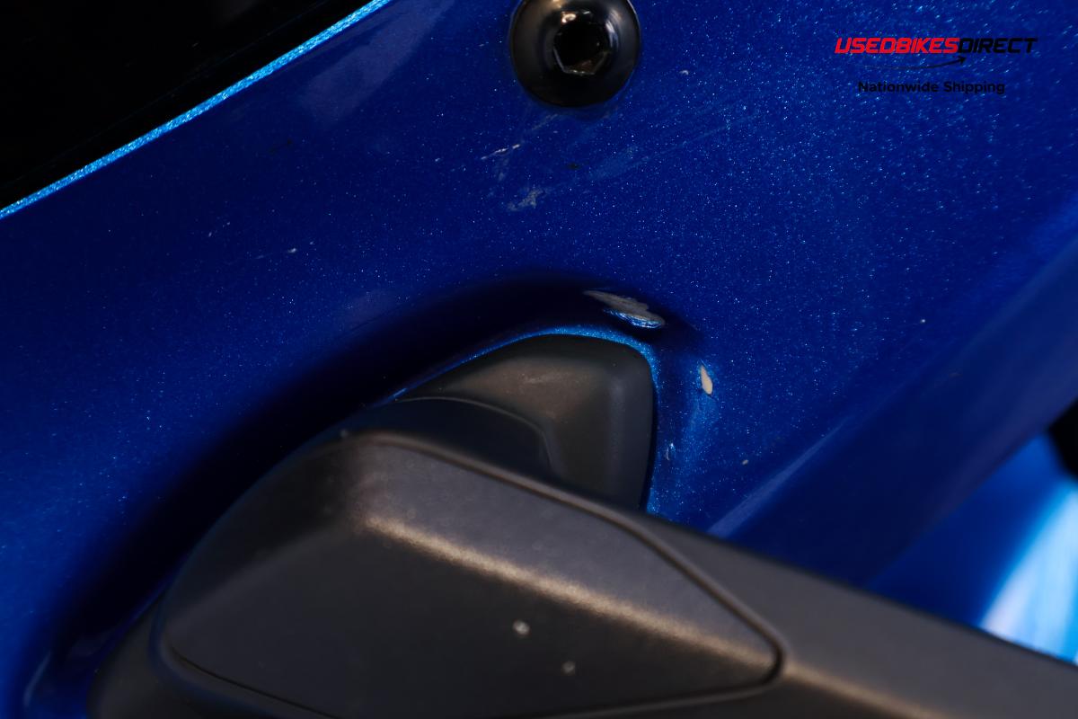 rust and dent on tank, cracks and paint chips on faring pieces, road rash on rear peg and gap on faring piece near tank.