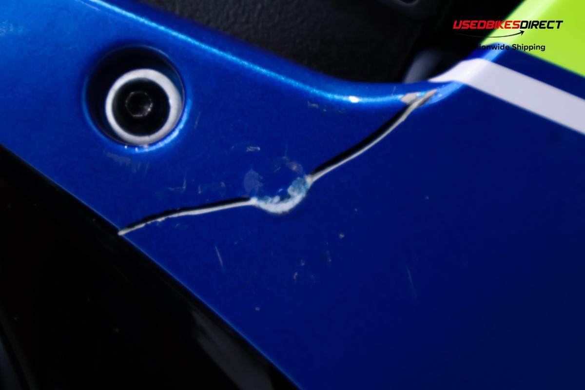 rust and dent on tank, cracks and paint chips on faring pieces, road rash on rear peg and gap on faring piece near tank.