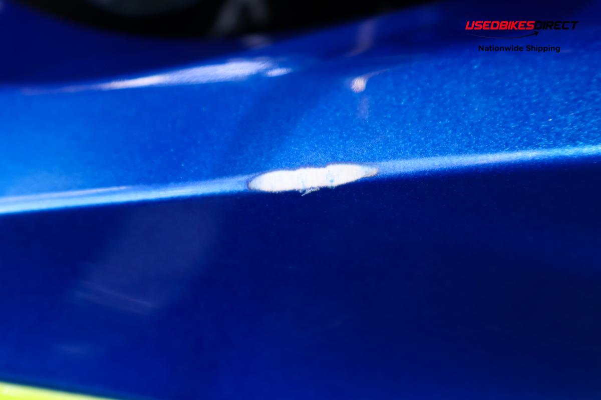 rust and dent on tank, cracks and paint chips on faring pieces, road rash on rear peg and gap on faring piece near tank.