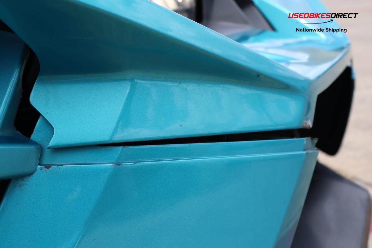 decals peeling off, cracks on bumper, damage to front bumper, road rash on side marker