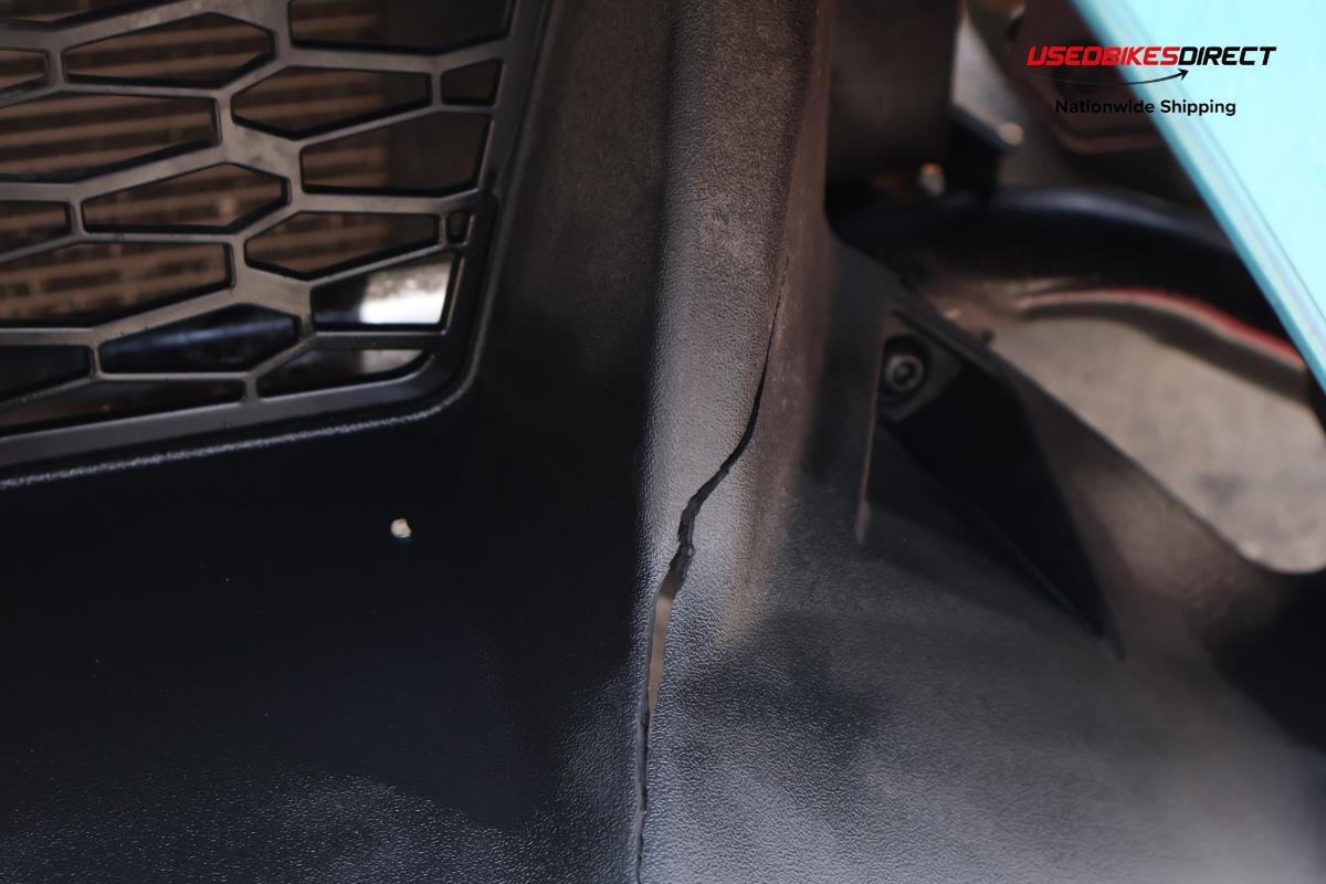 decals peeling off, cracks on bumper, damage to front bumper, road rash on side marker