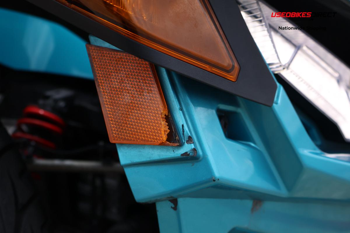 decals peeling off, cracks on bumper, damage to front bumper, road rash on side marker