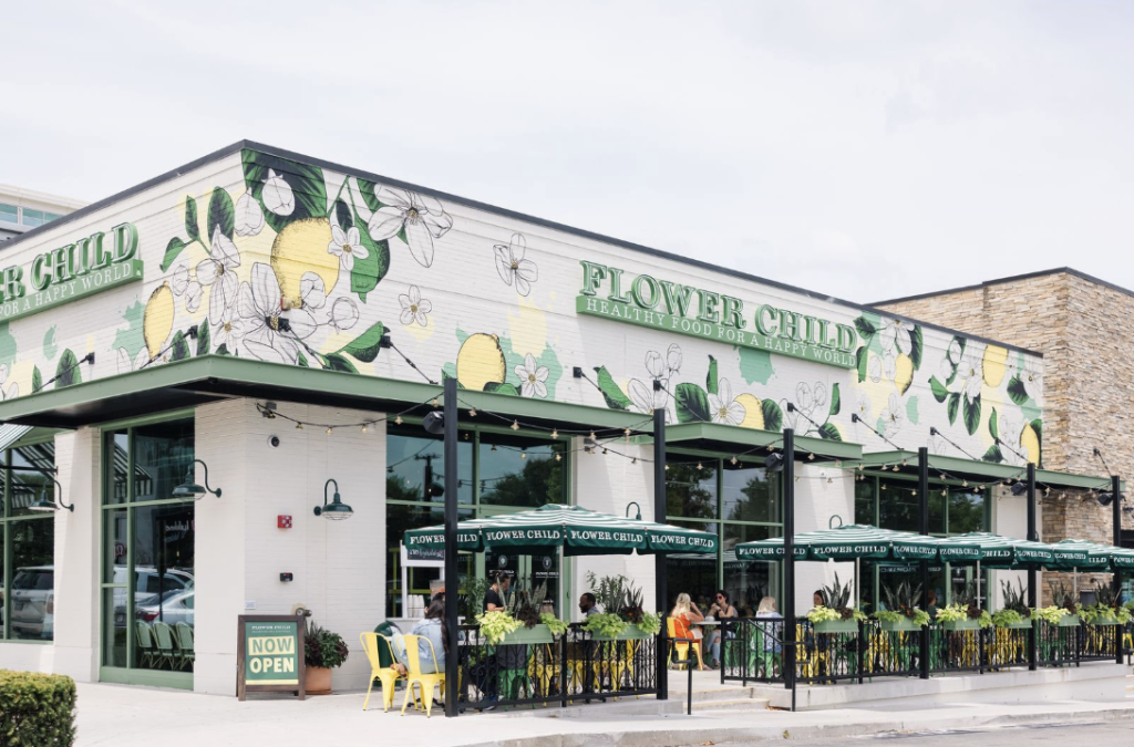 A brightly painted restaurant with outdoor seating and flower-themed decor in Williamson County, Tennessee.