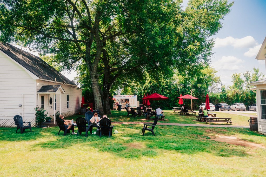 Best Family-Friendly Restaurants in Franklin People relaxing on a grassy lawn with picnic tables and a food truck in Williamson County, Tennessee.