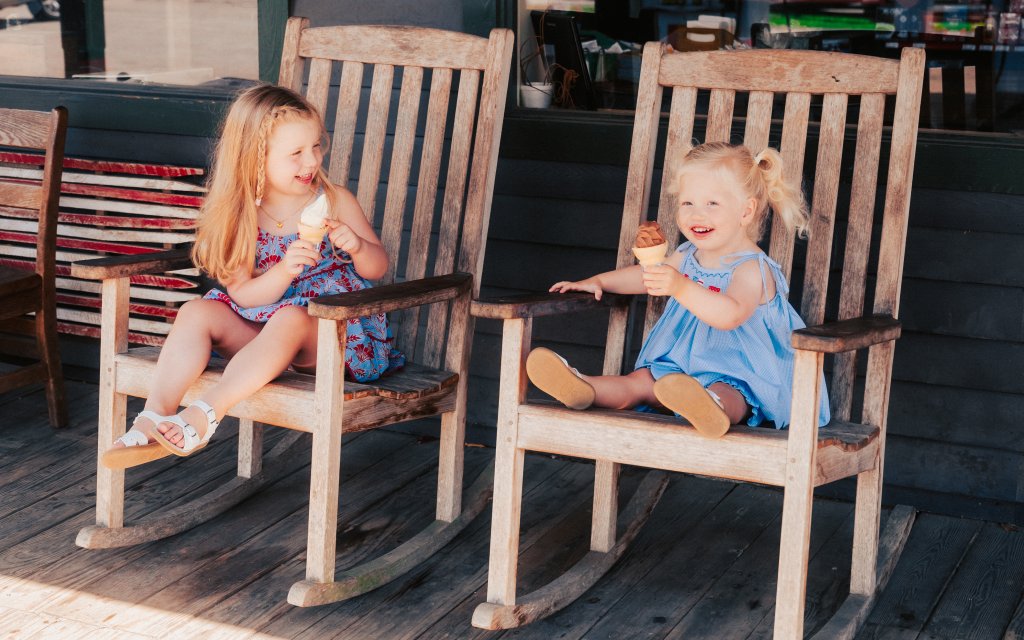 Best Family-Friendly Restaurants in Franklin Two young girls sit in wooden rocking chairs eating ice cream cones in Williamson County, Tennessee.