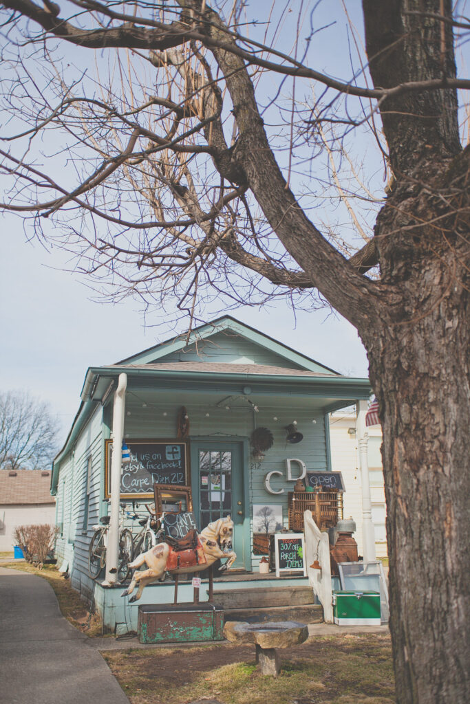 A charming, light blue house with a porch, decorated with eclectic items and bicycles in Williamson County, Tennessee.