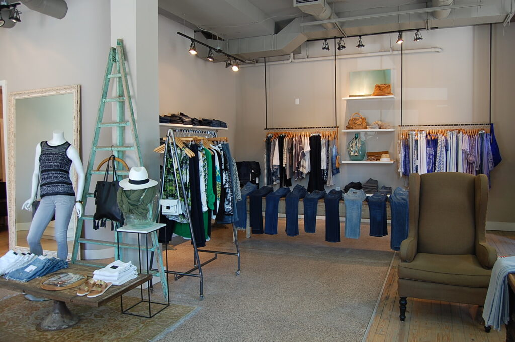 A stylish clothing boutique with a ladder, mannequins, and a variety of women's apparel on display in Williamson County, Tennessee.