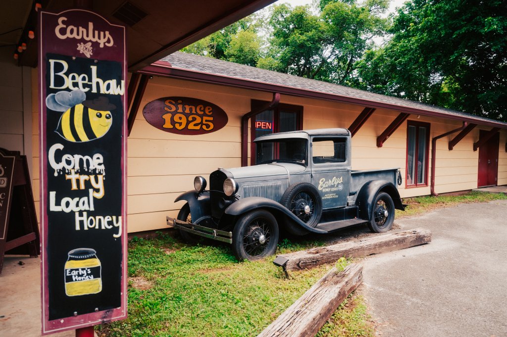 Your Guide to Discovering the Best of Spring Hill, Tennessee A vintage pickup truck parked outside a honey shop with a bee-themed sign in Williamson County, Tennessee.