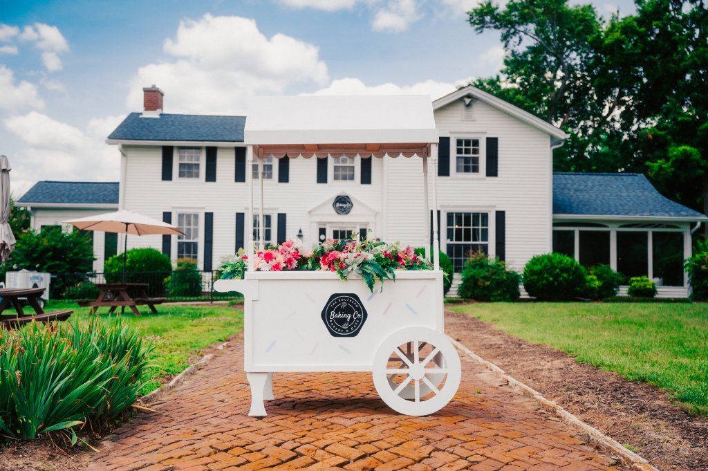 Your Guide to Discovering the Best of Spring Hill, Tennessee A white decorative cart filled with flowers sits on a brick path before a house in Williamson County, Tennessee.