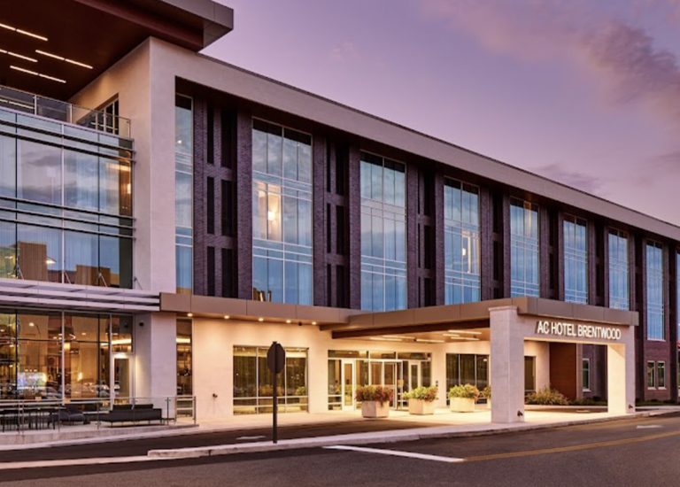 Brentwood A modern hotel with a glass facade and illuminated entrance at dusk in Williamson County, Tennessee.