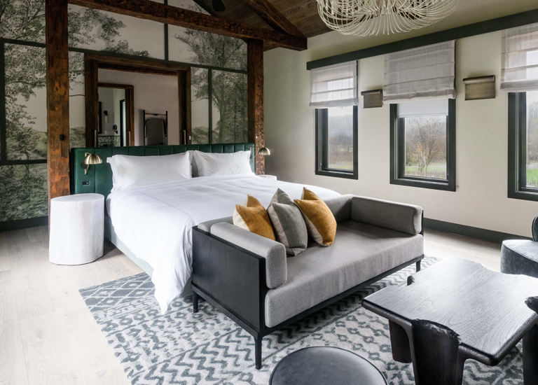 Franklin A modern bedroom with a large bed, plush sofa, and rustic-chic decor in Williamson County, Tennessee.