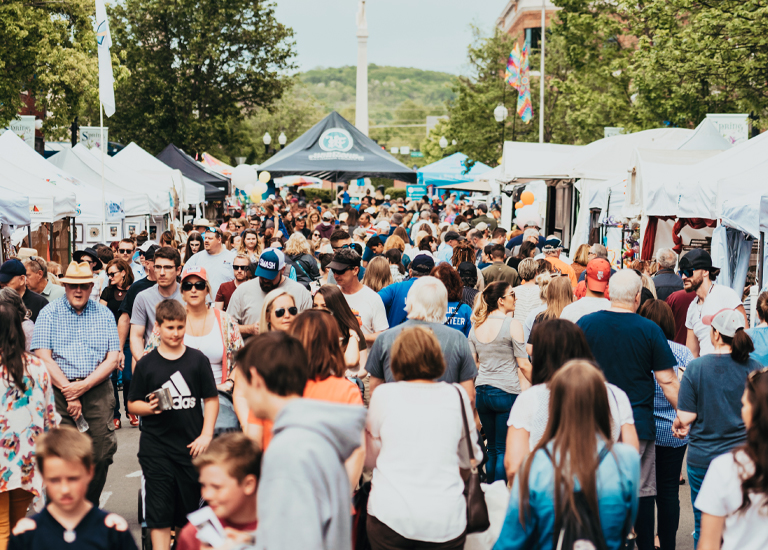 Franklin A bustling outdoor market with numerous white tents, filled with shoppers and vendors in Williamson County, Tennessee.