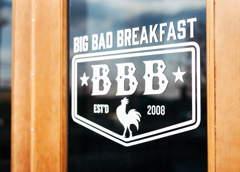 Spring Hill A sign on a wooden door advertises 'Big Bad Breakfast' with a rooster logo in Williamson County, Tennessee.