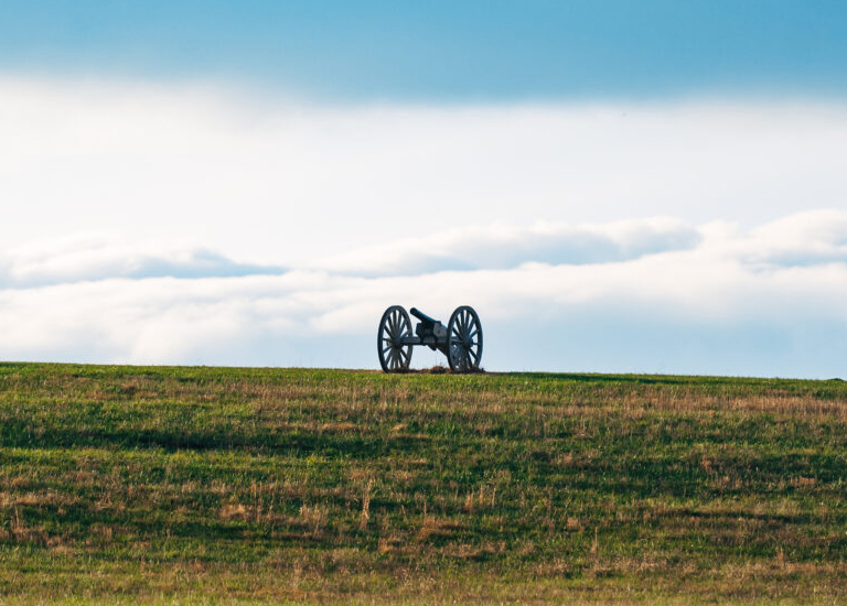 Spring Hill A cannon on wheels sits atop a grassy hill under a cloudy sky in Williamson County, Tennessee.