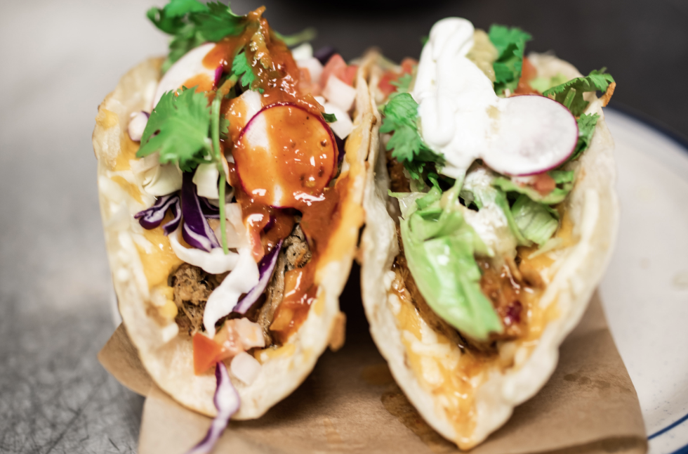 Taco ’Bout Tasty: 10 of Our Favorite Franklin Taco Joints Two colorful tacos with meat, cheese, vegetables, and sauces on a plate in Williamson County, Tennessee.