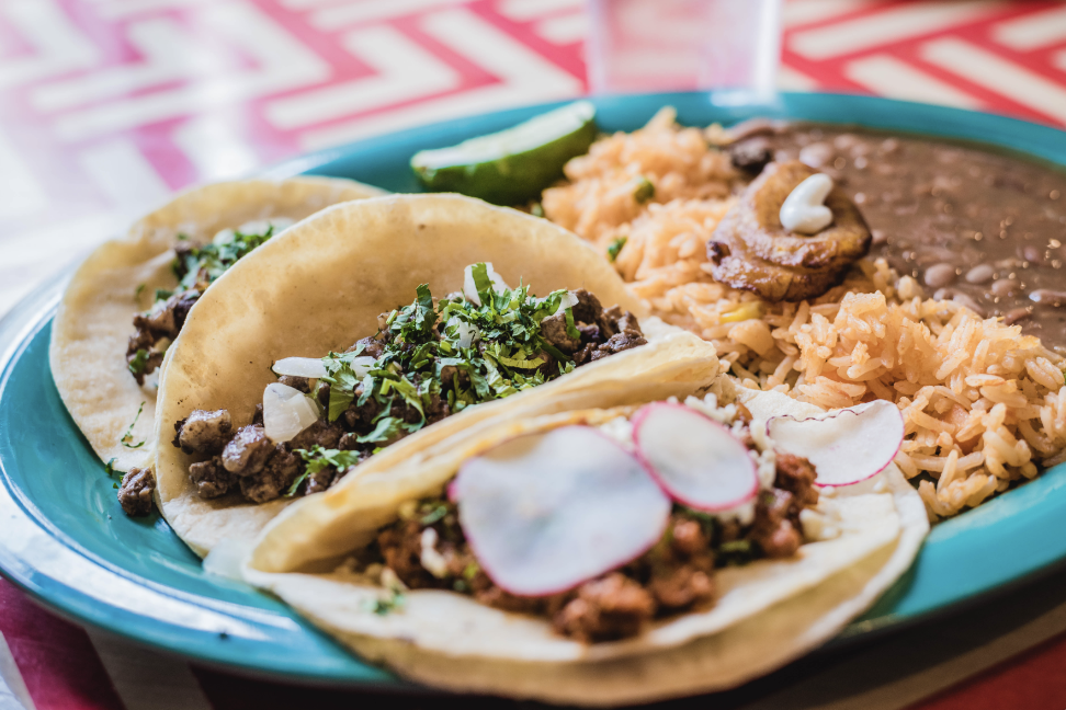 Taco ’Bout Tasty: 10 of Our Favorite Franklin Taco Joints A colorful plate of Mexican food featuring tacos, rice, beans, and plantains in Williamson County, Tennessee.