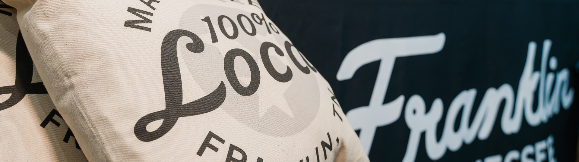 Contact Us Two white pillows with '100% Local' text and a black banner with 'Franklin' script logo in Williamson County, Tennessee.