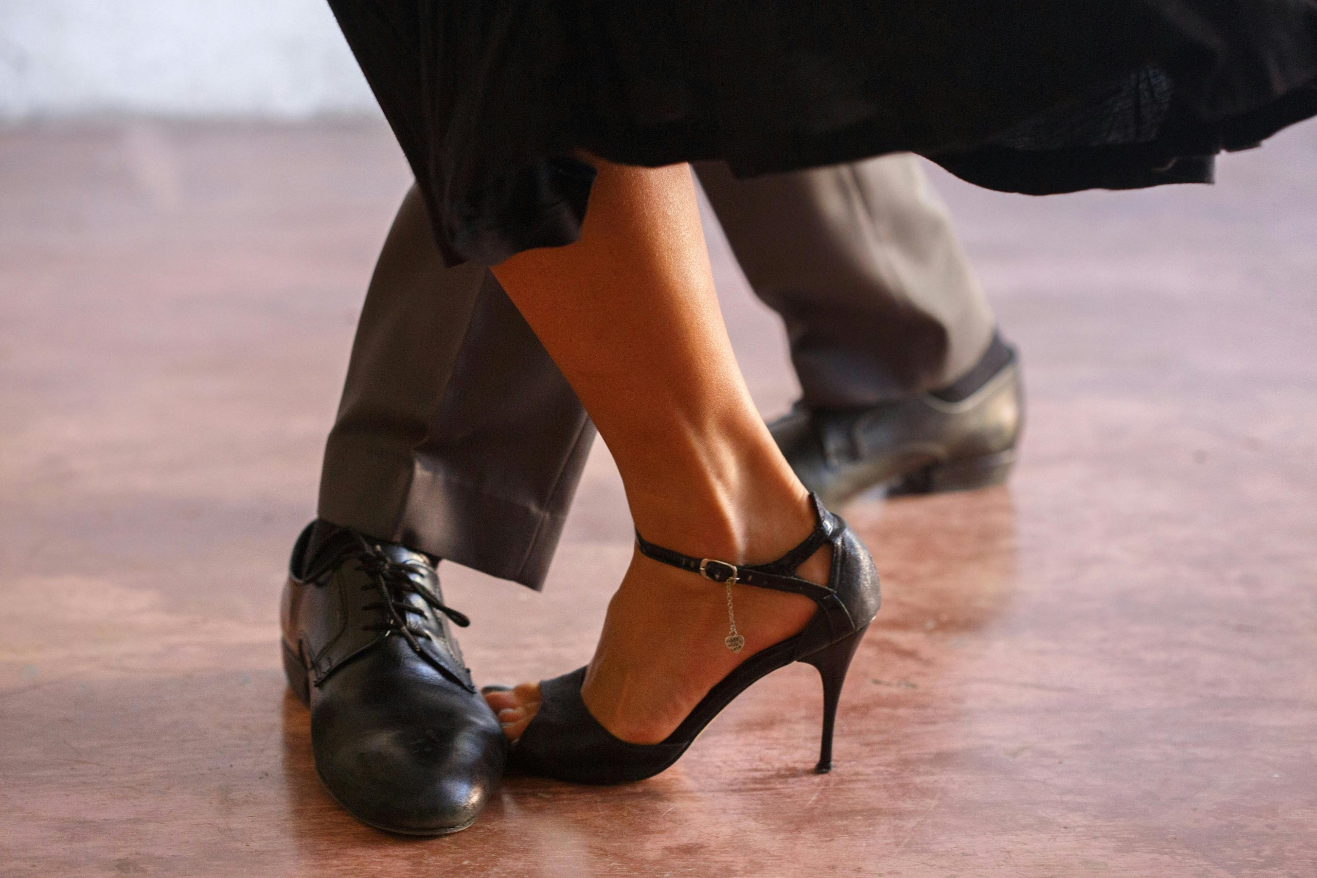 Ballroom Dancing Class | Foxtrot and Tango Two dancers in black shoes perform a close dance move on a wooden floor in Williamson County, Tennessee.