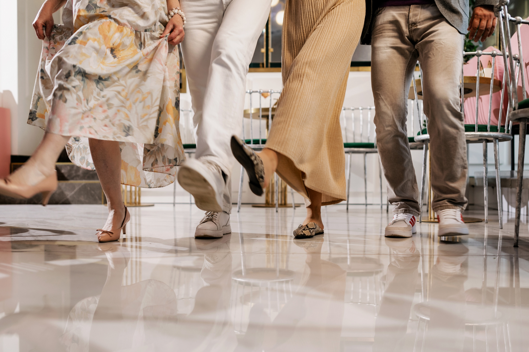Line Dancing Class Four people in stylish clothing walking on a shiny floor in a modern indoor setting in Williamson County, Tennessee.