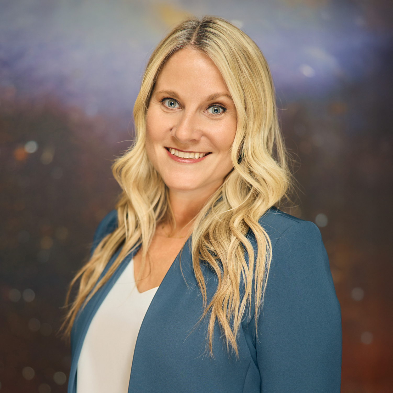 Meet The Team A smiling woman with long blonde hair wearing a blue blazer over a white shirt in Williamson County, Tennessee.