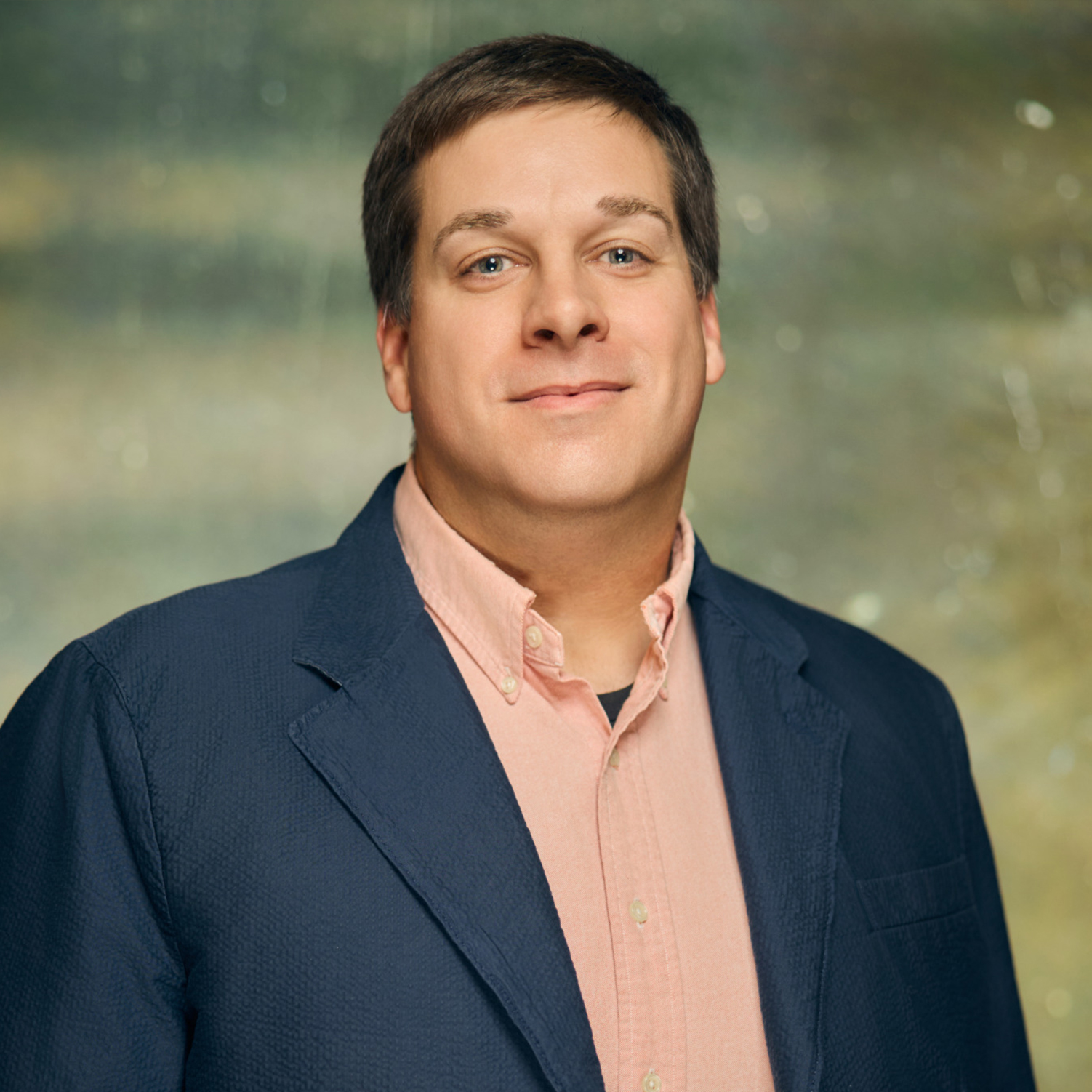 Meet The Team A smiling man with short brown hair wearing a pink shirt and navy blazer in Williamson County, Tennessee.